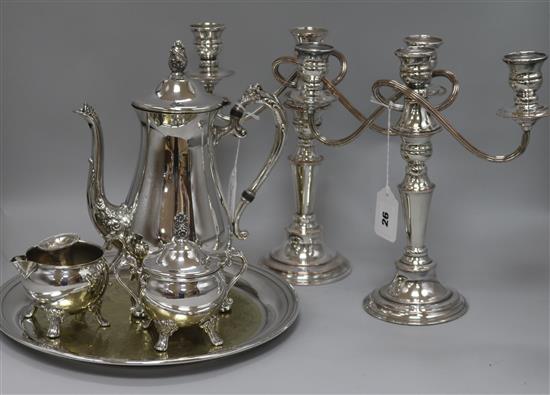 A pair of plated candelabrum, a three-piece plated coffee set, a circular tray and a dwarf candlestick